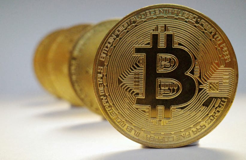  A representation of the virtual cryptocurrency Bitcoin is seen in this picture illustration taken October 19, 2021.  (credit: EDGAR SU/ REUTERS)