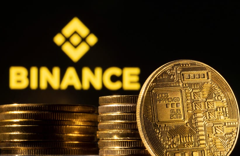  A representation of the cryptocurrency is seen in front of Binance logo in this illustration taken, March 4, 2022.  (credit: REUTERS/DADO RUVIC/ILLUSTRATION)