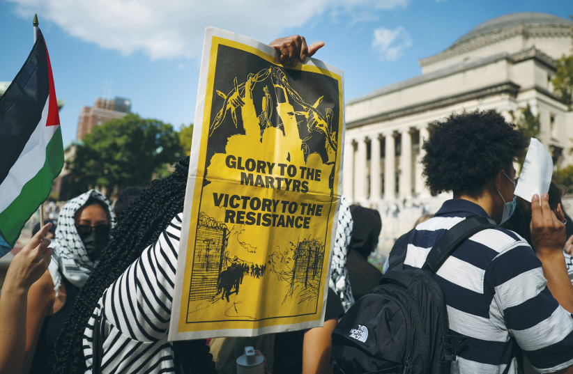 A PRO-PALESTINIAN demonstrator holds a sign that reads, ‘Glory to the martyrs, victory to the resistance,’ on Columbia University campus, on the first anniversary of the Hamas attack on Israel. (credit: Mike Segar/Reuters) A PRO-PALESTINIAN demonstrator holds a sign that reads, ‘Glory to the martyrs, victory to the resistance,’ on Columbia University campus, on the first anniversary of the Hamas attack on Israel. (credit: Mike Segar/Reuters)