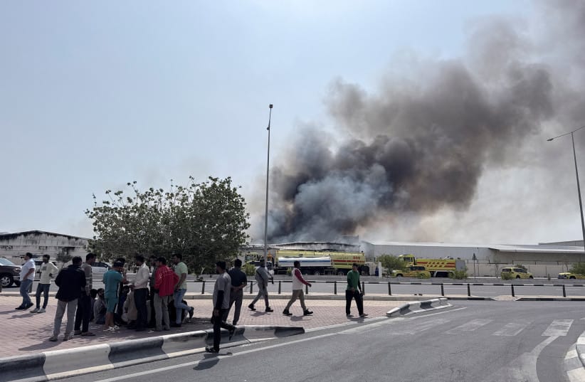 People gather as smoke rises at the Industrial Area after reported Iranian missile attacks, following United States and Israel strikes on Iran, in Doha, Qatar, March 1, 2026 (credit: REUTERS/MOHAMMED SALEM)