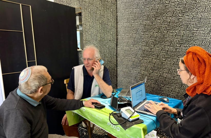 Dr. Ishai Lev, Director of the Tzur and Abu Gosh Clinics, sees patients at a makeshift clinic in Jerusalem for evacuees from Beit Shemesh.  (credit: Clalit Jerusalem District)