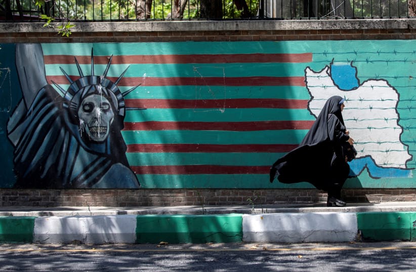 A woman walks past the mural showing U.S. flag with barbed wire and the Statue Of Liberty with skull face in Tehran, Iran June 25, 2019. (credit: Nazanin Tabatabaee/Nazanin Tabatabaee/West Asia News Agency via REUTERS) A woman walks past the mural showing U.S. flag with barbed wire and the Statue Of Liberty with skull face in Tehran, Iran June 25, 2019. (credit: Nazanin Tabatabaee/Nazanin Tabatabaee/West Asia News Agency via REUTERS)