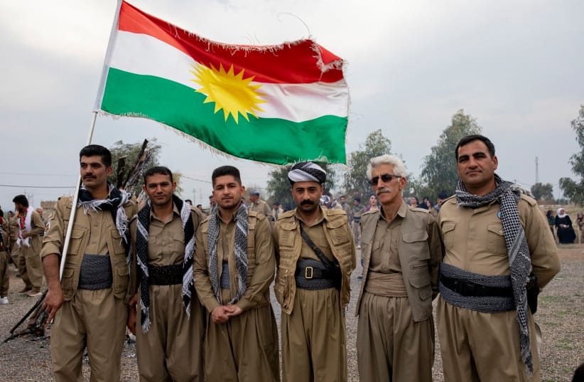 The Democratic Party of Iranian Kurdistan (PDKI) members pose for the camera as they celebrate Nowruz at the Jezhnikan Village around Baharka, Iraq, on March 18, 2025.  (credit: YOUNES MOHAMMAD/Middle East Images/AFP via Getty Images)