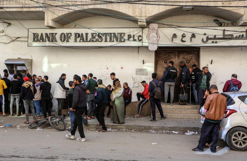 Employees of the Palestinian Authority line up at the ATM outside the Bank of Palestine in Rafah, in the southern Gaza Strip, on December 8, 2023 (credit:  Abed Rahim Khatib/Flash90)