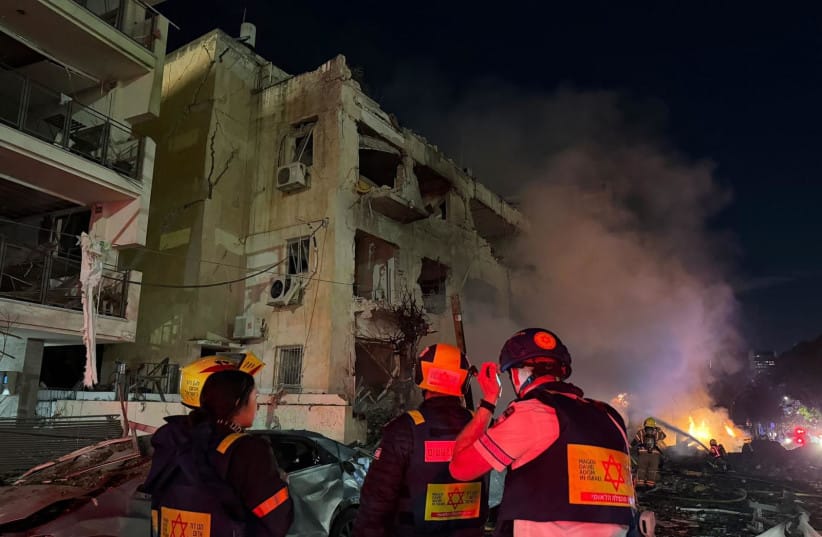Magen David Adom responds after a Tel Aviv building is hit by an Iranian rocket.  (credit: Courtesy Magen David Adom)