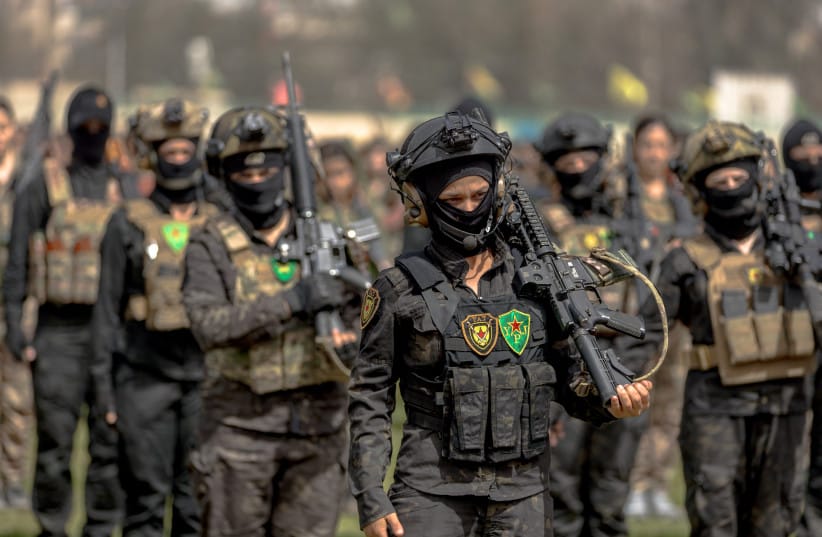 Members of the Anti-Terror Units YAT of the Women's Protection Units YPJ stand in formation during a military parade marking the thirteenth anniversary of the forces' founding in Qamishli, northern Syria, on April 4, 2026 (credit: Amjad Kurdo/Middle East Images/AFP via Getty Images)