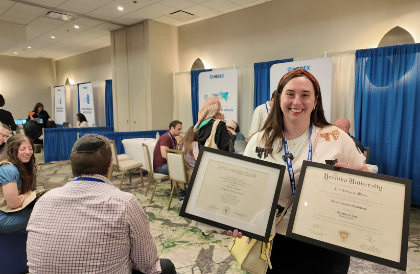 Genetic counselor, Talia Kupferman shows off her framed degrees taken from off the wall to bring to the MedEx event. (credit: EZRA TAYLOR/THE JERUSALEM POST)
