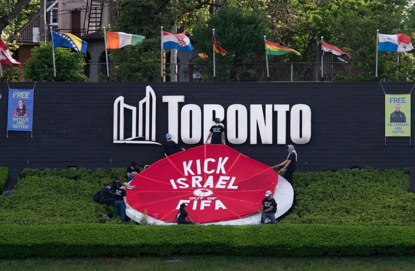  FBL-WC-2026-PRTOEST Activists place a banner covering the logo of the FIFA World Cup 2026 with the words ''Kick Israel out of FIFA'' in Toronto, Canada, June 12, 2026, on the day of the first game of the Canadian team in the World Cup against Bosnia-Herzegovina.  (credit: Jorge UZON / AFP via Getty Images)