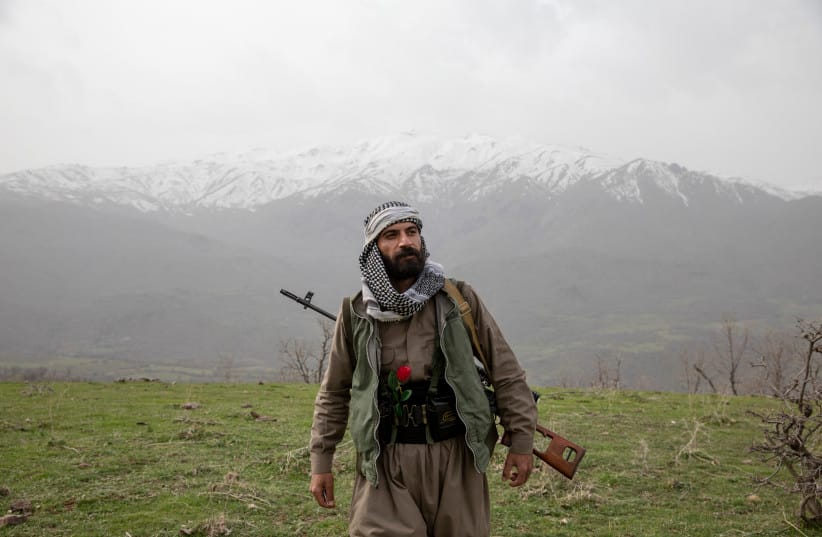 An armed Kurdish Peshmerga of the Komala party in a ceremony held in memory of Komala Martyrs' Day in Sidakan, Kurdistan Region of Iraq, on March 17, 2021. (credit: YOUNES MOHAMMAD/Middle East Images/AFP via Getty Images)