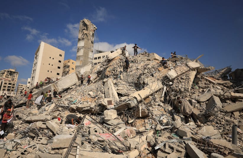 Palestinians inspect the site of an Israeli airstrike that destroyed a residential building in Gaza City, September 6, 2025; Illustrative. (credit: REUTERS/DAWOUD ABU ALKAS)
