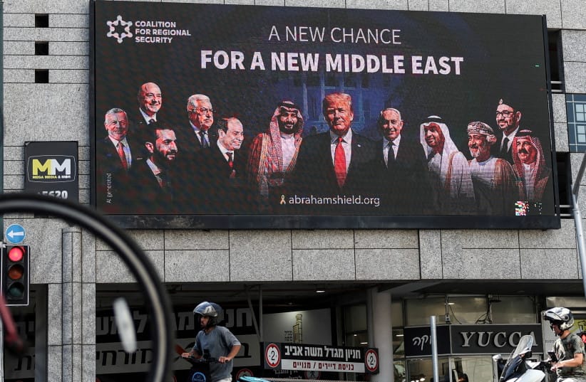 People walk by a billboard sponsored by the Coalition for Regional Security calling for the expansion of the Abraham Accords, in Ramat Gan (credit: Violeta Santos Moura/Reuters) People walk by a billboard sponsored by the Coalition for Regional Security calling for the expansion of the Abraham Accords, in Ramat Gan (credit: Violeta Santos Moura/Reuters)