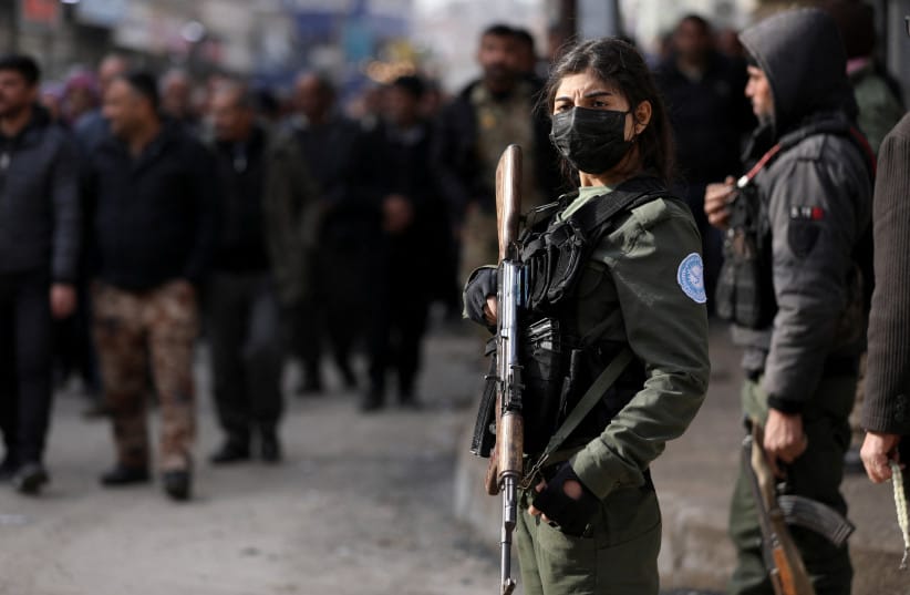 A Kurdish internal security forces member stands guard with a weapon as Syrian Kurds attend a protest in solidarity with the people in the neighborhoods of Sheikh Maqsoud and Ashrafieh in Aleppo, in Hasakah, Syria January 7, 2026. (credit: REUTERS/Orhan Qereman) A Kurdish internal security forces member stands guard with a weapon as Syrian Kurds attend a protest in solidarity with the people in the neighborhoods of Sheikh Maqsoud and Ashrafieh in Aleppo, in Hasakah, Syria January 7, 2026. (credit: REUTERS/Orhan Qereman)