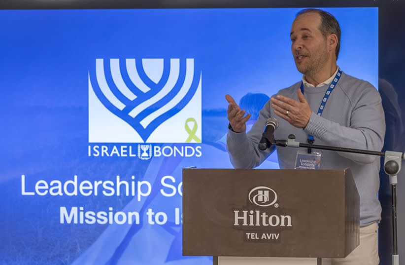 Larry Olschwanger addresses fellow leaders during the Israel Bonds Leadership Solidarity Mission to Israel (credit: SHAHAR AZRAN)