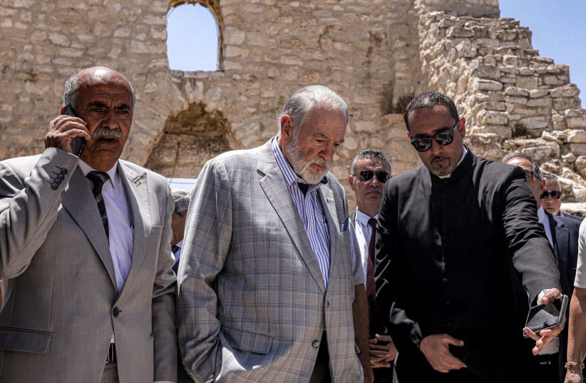 Huckabee (C) and the Palestinian mayor of the village of Taybeh, Suleiman Khourieh (L), tour the fifth-century Church of St George in the Palestinian Christian village of Taybeh, northeast of Ramallah in July 2025, days after an arson attack on the church. (credit: JAAFAR ASHTIYEH/AFP via Getty Images)