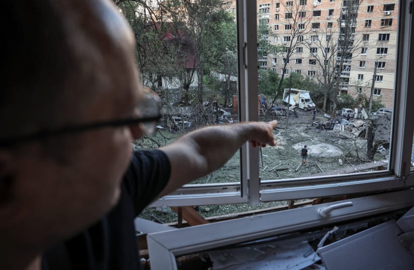 Mykola points at the results of Russian missile and drone strikes from the window of his damaged apartment, amid Russia&rsquo;s attack on Ukraine, in Kyiv, Ukraine, July 2, 2026.  (credit: Alina Smutko/Reuters)