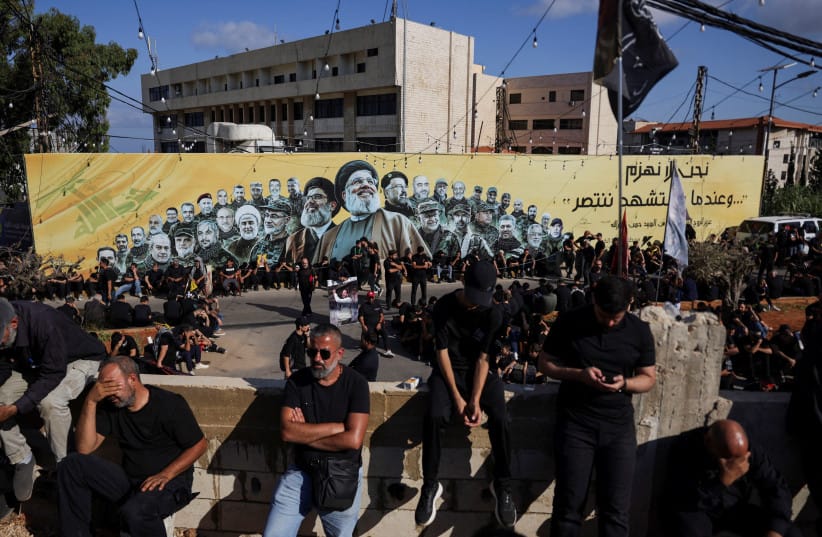 A flag depicting late former Hezbollah leader Hassan Nasrallah flutters as Shi'ite mourners mark Ashura, in the southern suburbs of Beirut, Lebanon, June 26, 2026 (credit: REUTERS/KHALIL ASHAWI)