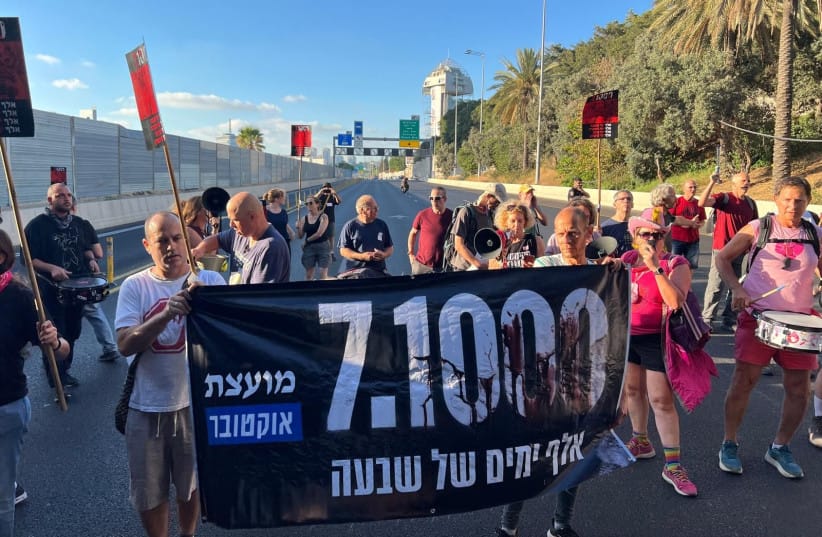 1000 days since the October 7th massacres. Protestors in Tel Aviv block the Ayalon Freeway. The banner reads &ldquo;1000 days of shiva [mourning]&rdquo; (credit: YAEL GADOT)