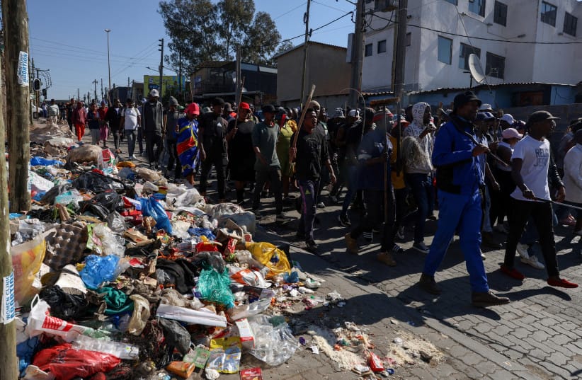 People march as anti-immigrant protesters go door-to-door in search of undocumented foreign nationals, after an unofficial June 30 deadline set by anti-immigrant groups for undocumented migrants to leave the country had passed, in Alexandra township, South Africa, July 9, 2026. (credit:  REUTERS/Oupa Nkosi/File Photo)