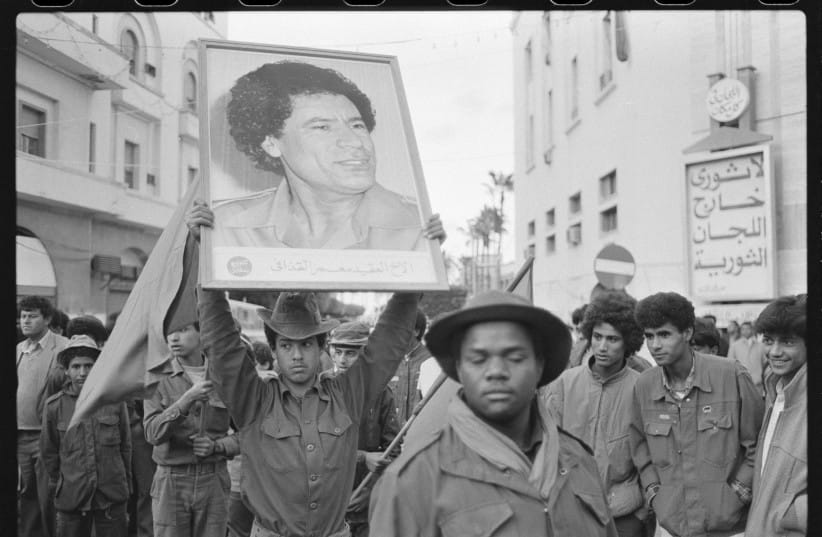 COLONEL MUAMMAR QADDAFI’S image is held up at a 1986 anniversary parade in Tripoli, celebrating the 1970 departure of the British from Libya. Also in 1970, Qaddafi ‘nationalized’ all Jewish property. (credit: Rob Taggart/Reuters) COLONEL MUAMMAR QADDAFI’S image is held up at a 1986 anniversary parade in Tripoli, celebrating the 1970 departure of the British from Libya. Also in 1970, Qaddafi ‘nationalized’ all Jewish property. (credit: Rob Taggart/Reuters)