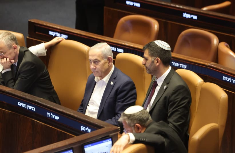Prime Minister Benjamin Netanyahu and Communications Minister Shlomo Karhi are seen in the Knesset plenum during a vote on the minister's communications reform, in Jerusalem, July 16, 2026 (credit: MARC ISRAEL SELLEM/THE JERUSALEM POST)