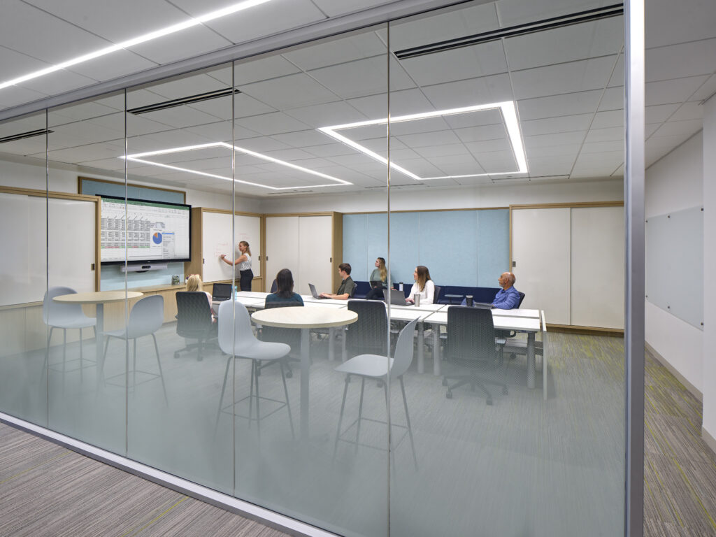 In one life sciences workplace, large team environments are anchored by robust audiovisual systems that enable seamless interaction between in-person and global, remote participants without compromising spatial efficiency. 