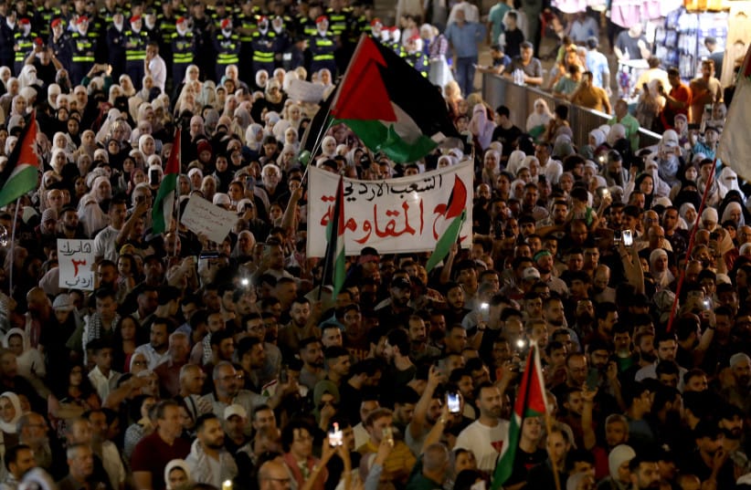  Demonstrators take part in a march in support of Palestinians in Gaza and to salute the slain Jordanian who shot and killed three Israeli civilians, according to the Israeli authorities, at the Allenby Bridge border crossing in the West Bank, in Amman, Jordan September 8, 2024.  (credit: Alaa Al Sukhni/Reuters)