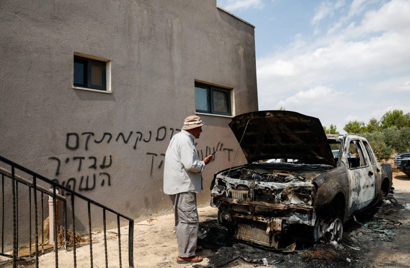 A Palestinian man inspects a vehicle damaged in what Palestinians say was an settler attack, in Deir Abu Masha'al, near Ramallah, in the West Bank, September 28, 2026 (credit: REUTERS/MOHAMAD TOROKMAN)