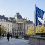 AI-generated illustration of a European civic square with European Union flags.