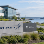 Lockheed Martin and Ultra Maritime signs beside a waterfront defense campus