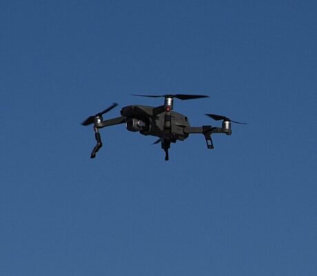 DJI Mavic 2 Pro drone in flight against a blue sky.