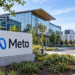 Meta sign and blue infinity logo outside a modern corporate campus