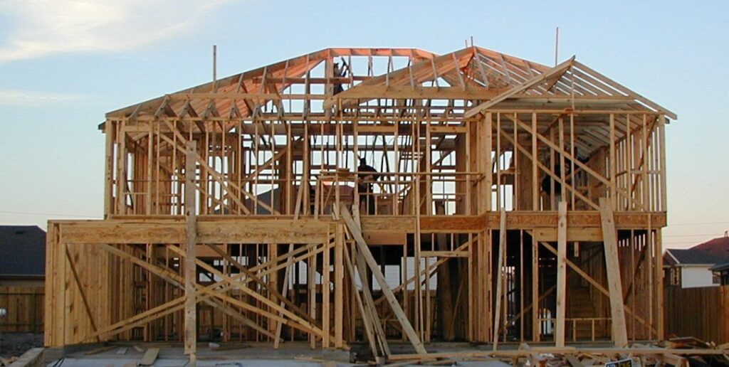 A wood-framed house under construction in Katy, Texas, in an archival photograph.