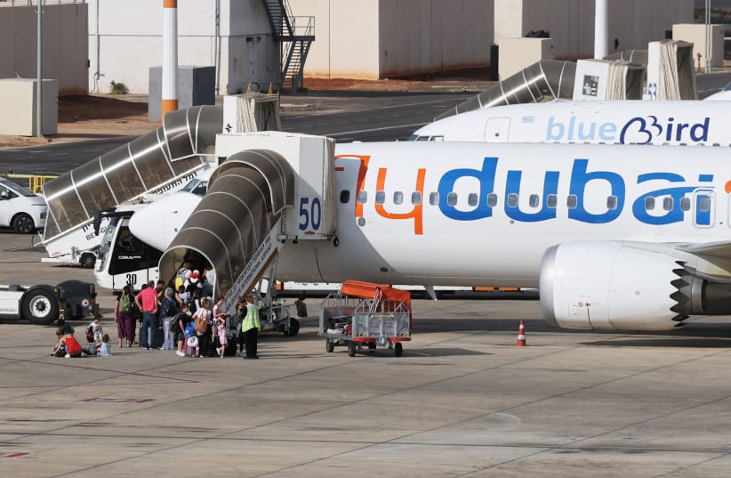 Travelers board a flydubai aircraft at Ben Gurion International Airport after a separate FlyDubai flight from the United Arab Emirates to Israel was diverted to Saudi Arabia following an emergency signal, on September 30, 2026. (credit: AMMAR AWAD/REUTERS)