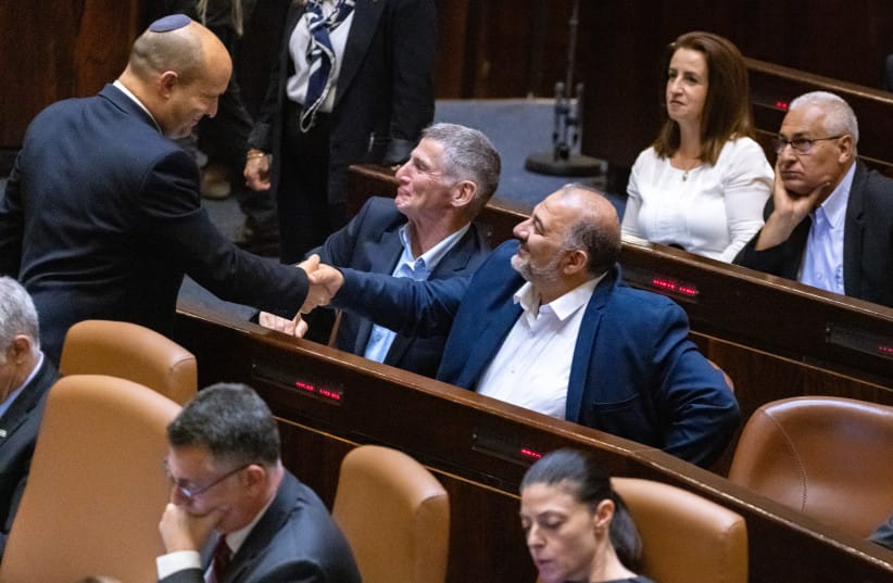 Then-prime minister Naftali Bennet with with head of the Ra'am party Mansour Abbas in the assembly hall of the Israeli parliament on June 21, 2021. (credit: OLIVIER FITOUSSI/FLASH90) Then-prime minister Naftali Bennet with with head of the Ra'am party Mansour Abbas in the assembly hall of the Israeli parliament on June 21, 2021. (credit: OLIVIER FITOUSSI/FLASH90)
