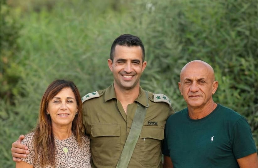 Clara and Ilan Hamami stand alongside their son, Asaf, who was killed on October 7, 2023. (credit: Hamami Family)