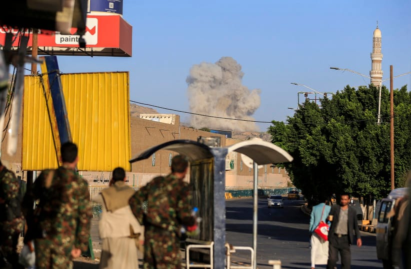 A plume of smoke rises during a reported airstrike by the Saudi-led coalition on the Houthi-controlled Yemeni capital Sana'a, October 9, 2026 (credit:  AFP via Getty Images)