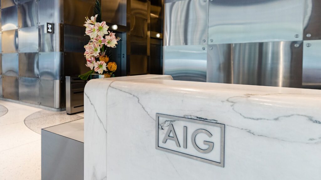 AIG headquarters lobby in New York, with AIG branding on the reception desk.