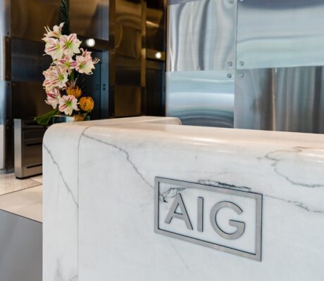 AIG headquarters lobby in New York, with AIG branding on the reception desk.