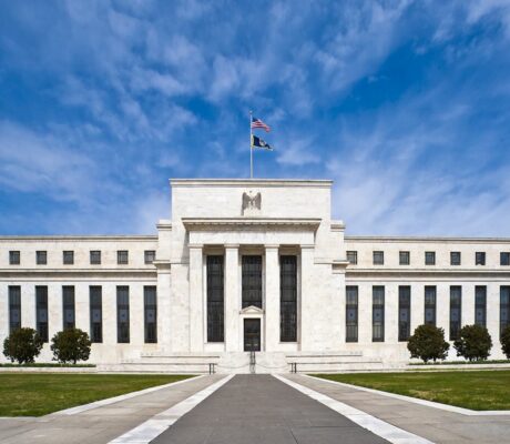 Federal Reserve Eccles Building with flags, archive photo, cropped. Federal Reserve / Wikimedia Commons, public domain.