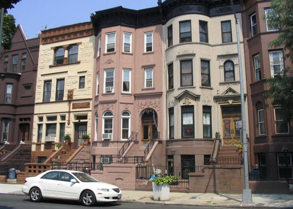 Archive photograph of Bedford-Stuyvesant brownstones in Brooklyn, illustrating a guide to NYC building records.