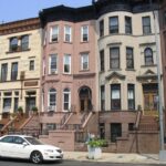 Archive photograph of Bedford-Stuyvesant brownstones in Brooklyn, illustrating a guide to NYC building records.