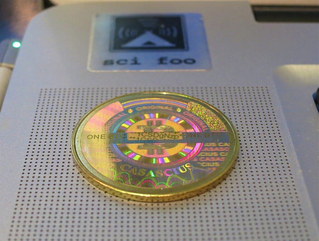 A gold-colored Casascius physical bitcoin coin.