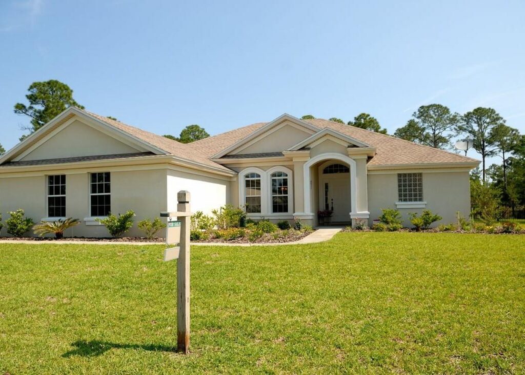 A suburban home with a for-sale sign. Illustrative archive, not a Redfin listing.