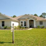 A suburban home with a for-sale sign. Illustrative archive, not a Redfin listing.