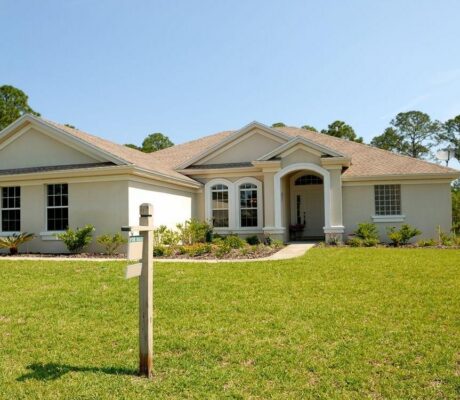 A suburban home with a for-sale sign. Illustrative archive, not a Redfin listing.