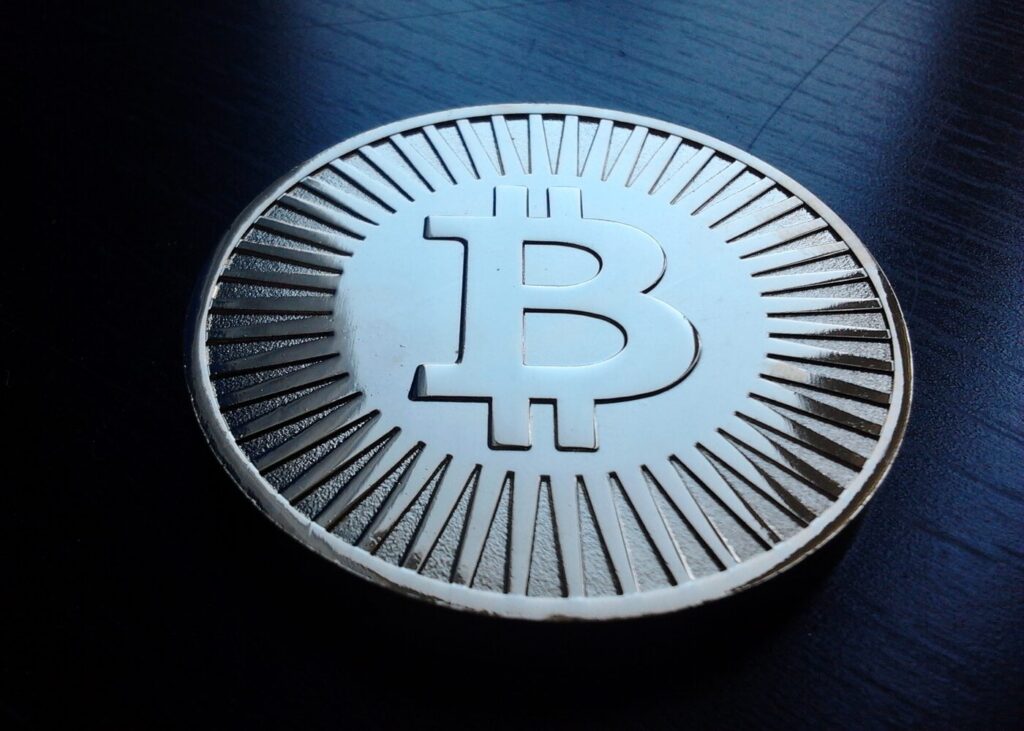 Archive photo: a silver bitcoin token on a dark surface