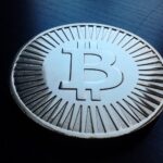 Archive photo: a silver bitcoin token on a dark surface