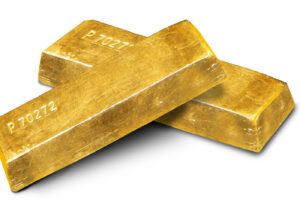 Archive photo: gold ingots stacked on a white background