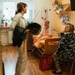 A caregiver and older adults in a residential care setting. Illustrative archive, not a U.S. facility assessed by CMS.