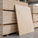 Stacked plywood panels in an industrial warehouse.